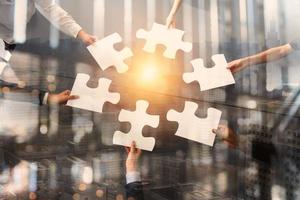 Teamwork of partners. Concept of integration and startup with puzzle pieces. Double exposure photo