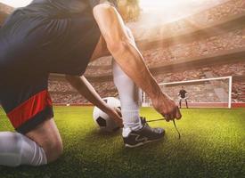 Close up perspective of a soccer scene match with player preparing to take the penalty kick photo