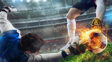 Goalkeeper tries to catch a fiery soccer ball photo