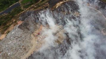 Aerial view smoke release from burning of garbage dump site video