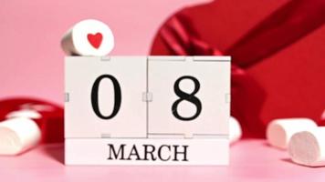 8 march creative card with heart shaped gifts, marshmallows and calendar with 8 march date video