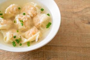 shrimp dumpling soup in white bowl photo