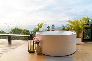 outdoor bath tub with beautiful mountain view background photo