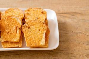 baked crispy bread with butter and sugar photo