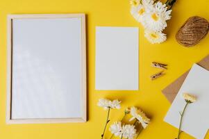 Photo frames and envelopes yellow background decorated with flowers