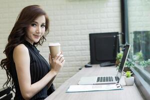 young beautiful working at computer desk photo