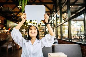 photo a young woman in a white shirt holding a thought box symbol