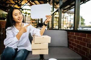 photo a young woman in a white shirt holding a thought box symbol