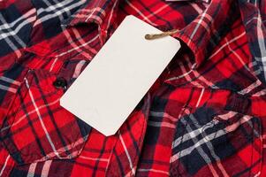 blank price tag label on plaid shirt photo