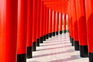 Japanese red wooden poles with blue sky and cloud.Walkway with red wooden poles Japanese style photo