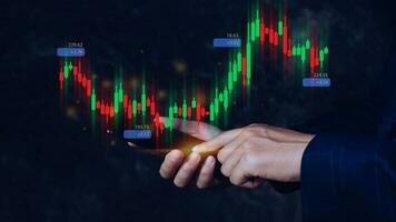 Hand of businessman or trader is showing growing virtual hologram stock on smartphone, planning and strategy, Stock market, Business growth, progress or success concept. invest in trading. photo