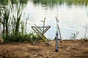 fishing pole on the river bank photo