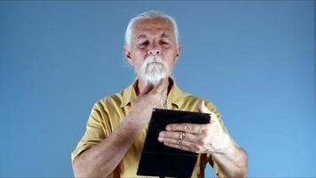 The Old Man Straightens His Beard Looking into the Mirror photo