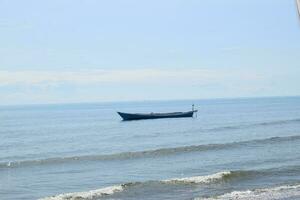 Wooden fishing boat in the blue sea, going to the ocean for fish. photo