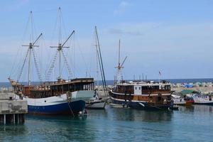 Wooden fishing boat anchored in the harbour. photo