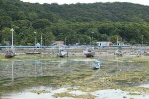 Wooden fishing boat anchored in the harbour. photo