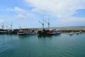 Wooden fishing boat anchored in the harbour. photo