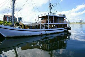 Indonesian traditional Phinisi ship. Pinisi or phinisi is a traditional two-masted Indonesian sailing ship. These boats are made to sail the waters of the Indonesian archipelago photo