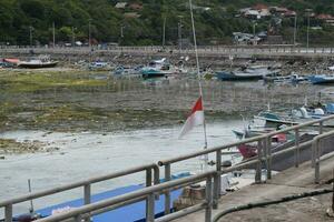 Wooden fishing boat anchored in the harbour. photo