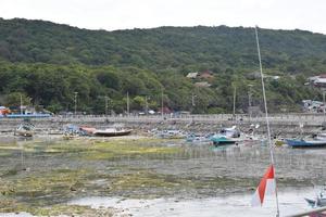 Wooden fishing boat anchored in the harbour. photo