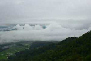 View of the Land above the Clouds village above the Clouds Lolai Hills Village and traditional village covered by clouds in the morning before sunrise photo