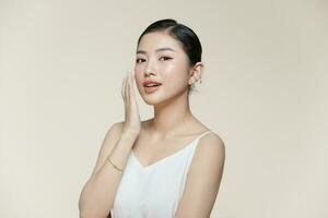 Happy young woman face with clear skin on brown background, closeup portrait photo