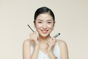 Charming young woman applying mascara. photo