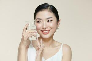 Young smiling woman holding water glass. photo