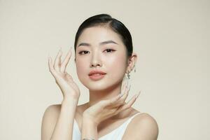 Smiling asian woman touching healthy skin portrait photo