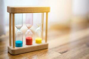 Colorful hourglasses with blurred background cute concept photo