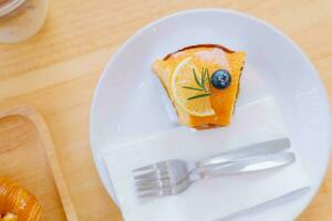 Top view piece of orange cake and sliced orange topping. Cake with orange mousse with copy space photo