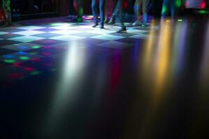 Disco in bar. Color music on dance floor. Bright colors in night club. photo
