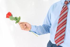 Man holding with red rose on white background photo