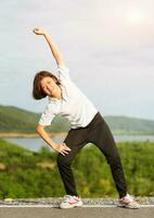 Woman doing exercising and warm up outdoor photo