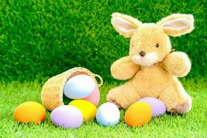 Bunny toy and Easter eggs in basket photo