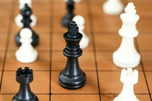 Chess pieces on wood chessboard photo