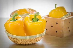 Fresh yellow bell peppers in basket photo