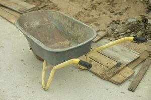 Sand cart. Transport at construction site. Transportation of materials. Yellow handles. photo