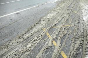 Sleet on road. Dirt on side of road. Details of road after precipitation. photo