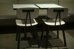 Table and chair. Interior with furniture. White small table. photo