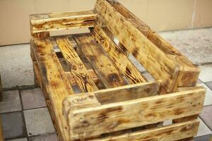 Bench made of boards. Craft furniture. Interior details. Cheap solutions. photo