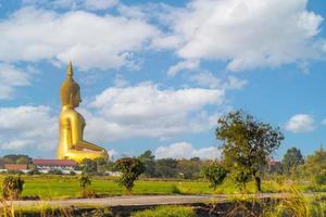 large golden yellow buddha At Wat Muang, which is an important religious tourist destination In Ang Thong Province in Thailand photo