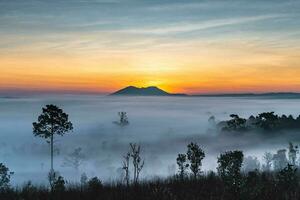 Thung Salaeng Luang National Park,The sun over the mountains and vast grasslands, Phetchabun Province, Thailand photo