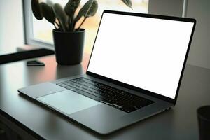 Creative White screen Mockup of a Laptop On The Desk. Empty Computer Design photo