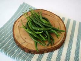 a bunch of fresh curly green chilies photo