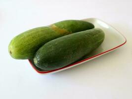 Fresh Green Cucumber Slice Fruits on White plate photo