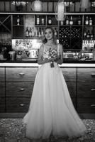 blonde bride in a bar near with a wedding bouquet photo