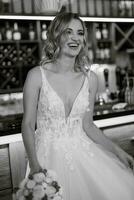 blonde bride in a bar near with a wedding bouquet photo