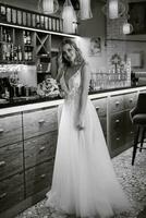 blonde bride in a bar near with a wedding bouquet photo