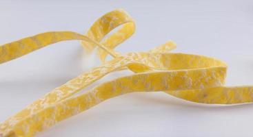 Italian pasta close-up Separate pasta ribbon on a white background. photo